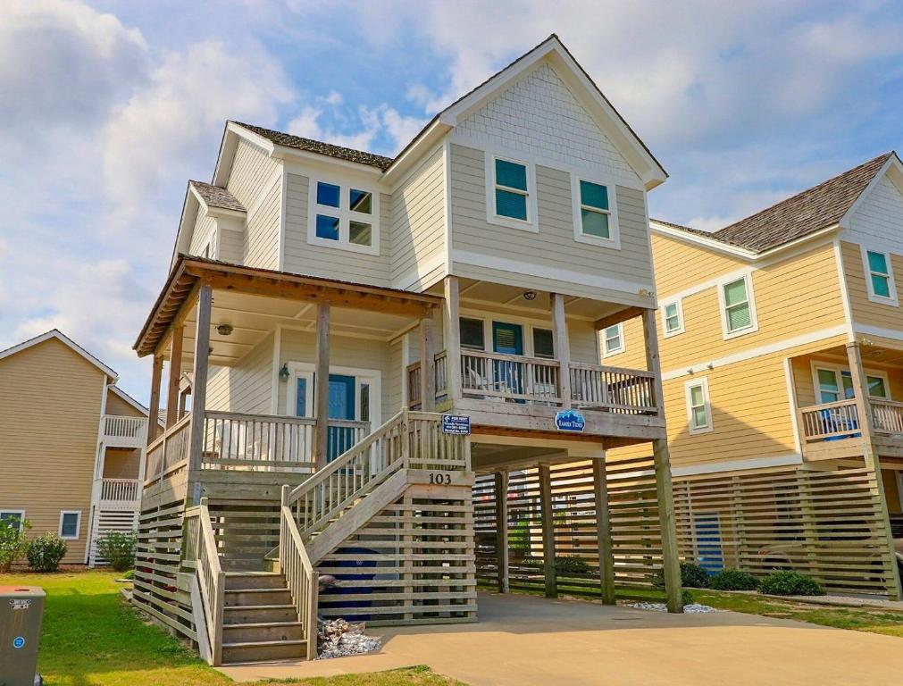 a large house with stairs in front of it at 6156 - Family Tides in Nags Head