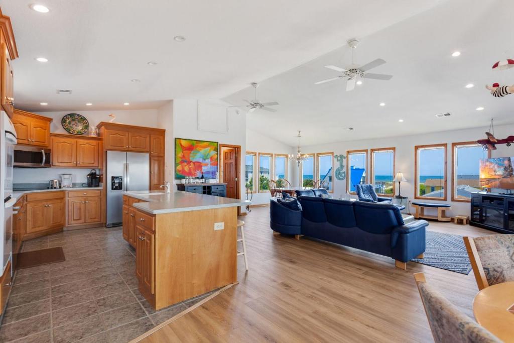 an open kitchen and living room with a blue couch at 7088 - Short II in Grun Island