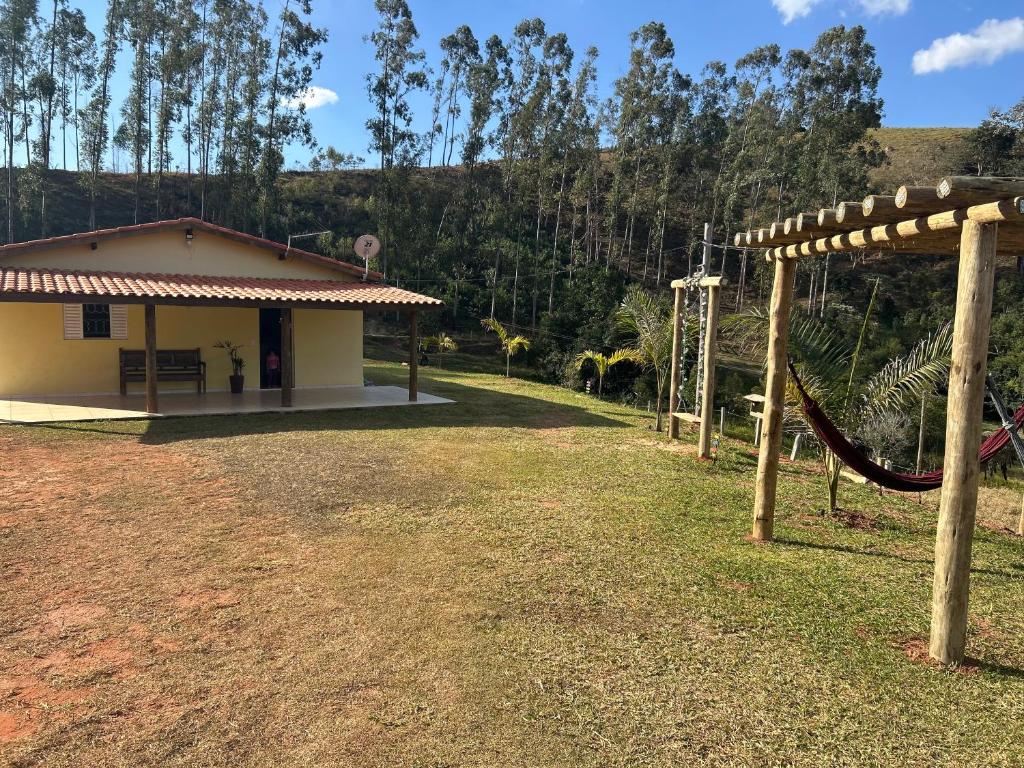 a playground in front of a building with a slide at Casa de Campo Sitio com tranquilidade in Cunha