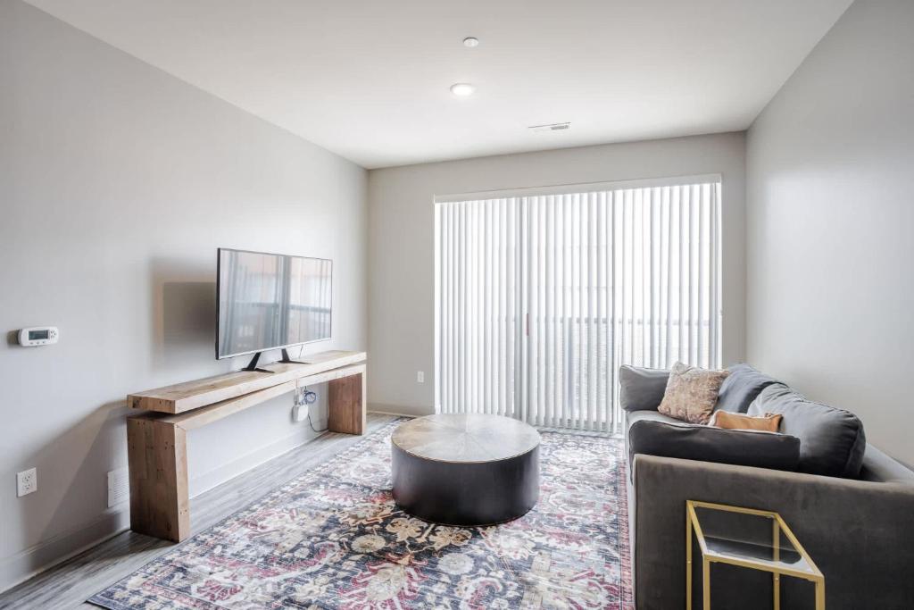 a living room with a couch and a tv at CozySuites at the Banks gym pool 15 in Cincinnati