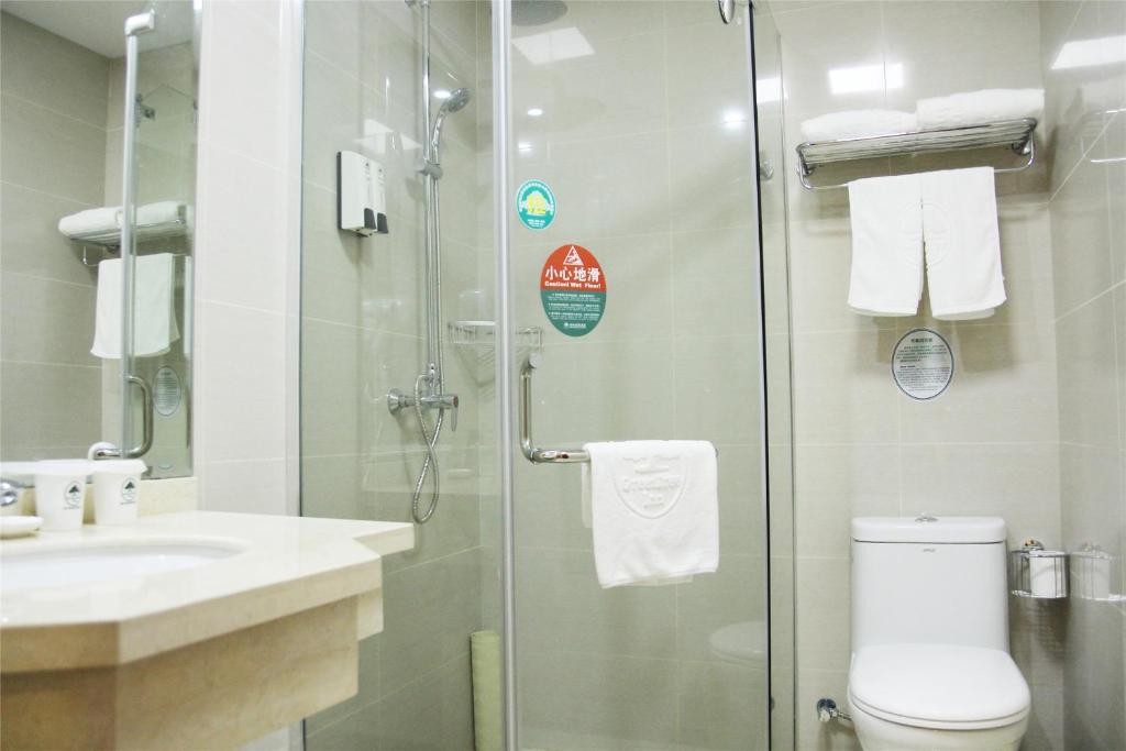 a bathroom with a shower and a toilet and a sink at GreenTree Inn Ji‘nan Shanda Road Business Hotel in Jinan