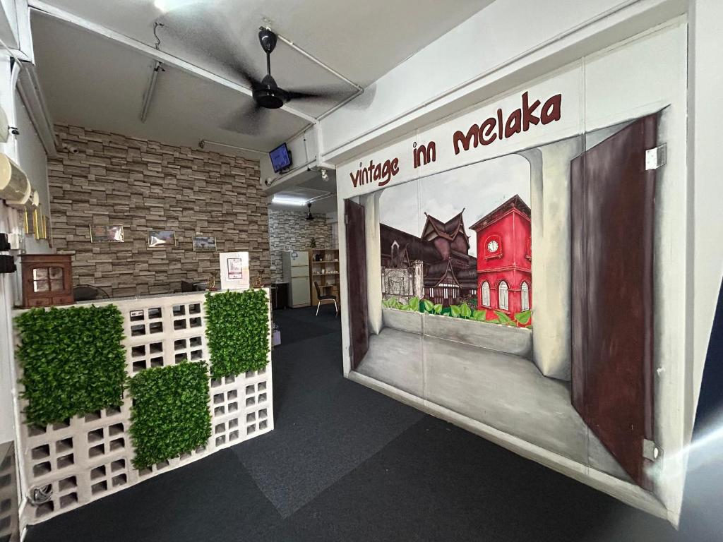 a room with a door with a sign that reads things in melaka at Vintage Inn Jonker Walk Melaka in Melaka