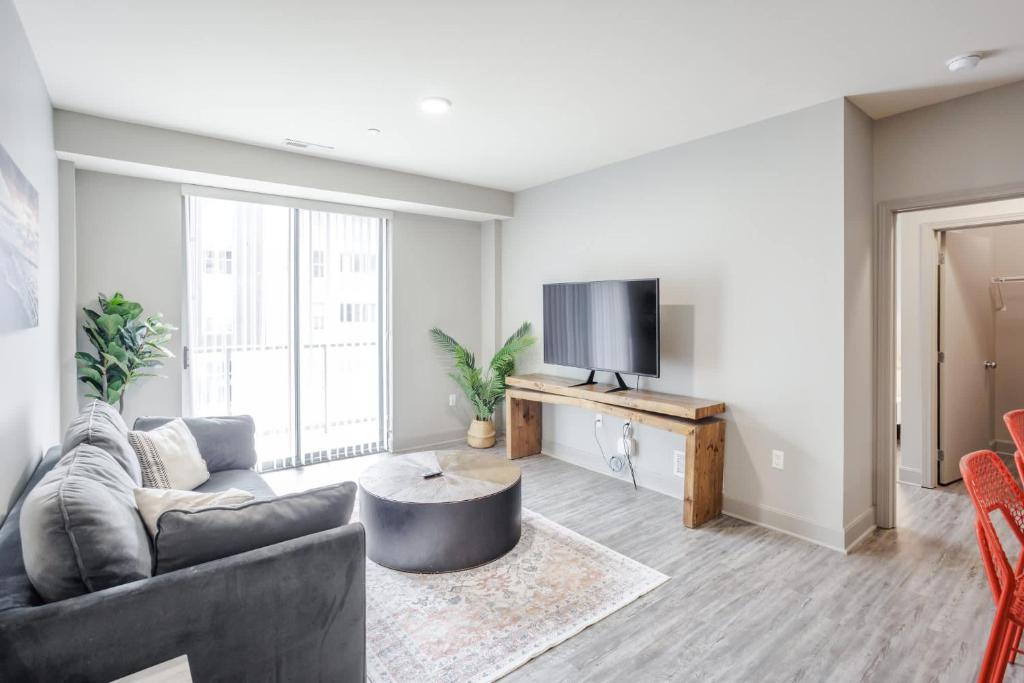 a living room with a couch and a tv at CozySuites at the Banks gym pool 08 in Cincinnati