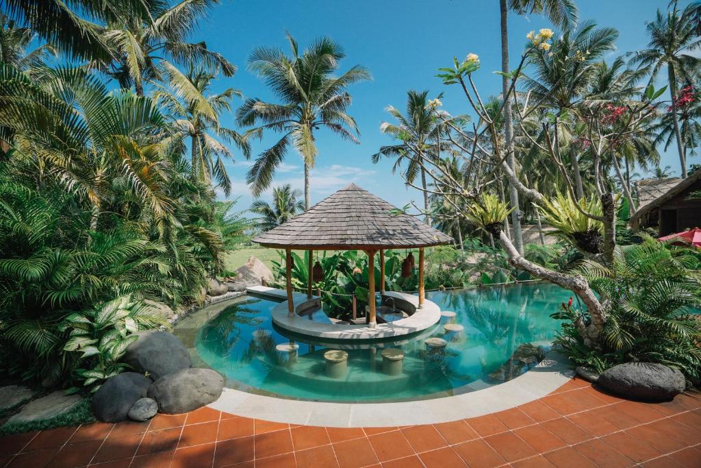 a swimming pool with a gazebo in a resort at Supersenang Boutique Resort Balian in Balian