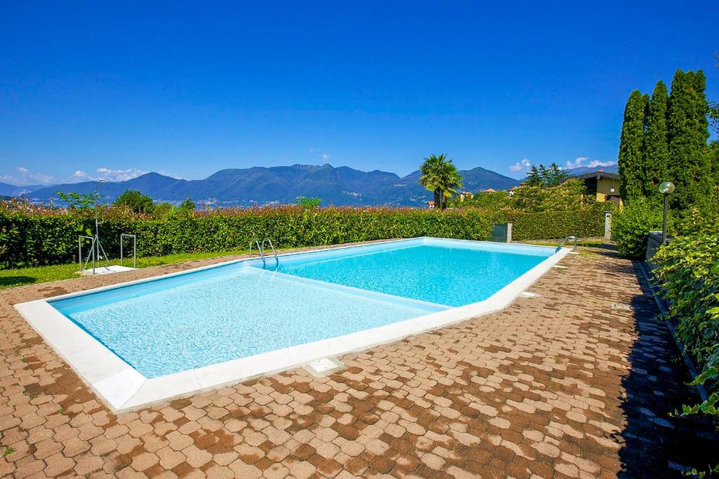 a swimming pool in the middle of a yard at Residenz Moncucco in Luino
