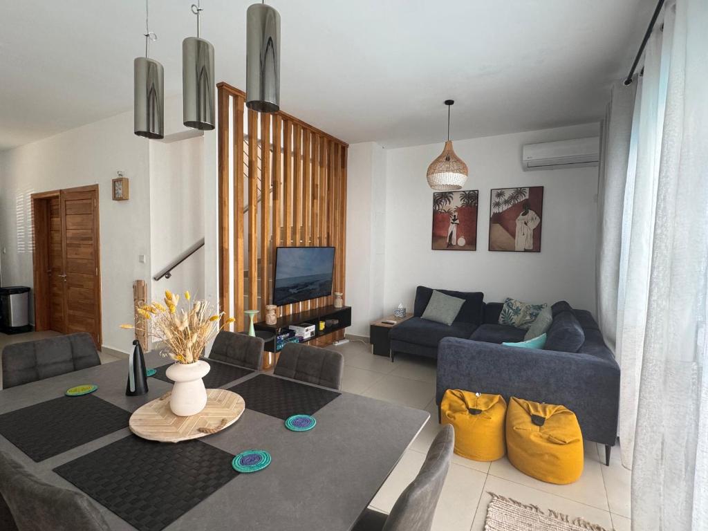 a living room with a couch and a table at Paddington House - private pool & rooftop in Flic-en-Flac