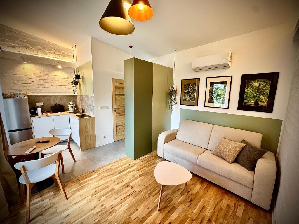 a living room with a couch and a table at Apartamenty Młyńska 3A in Gliwice
