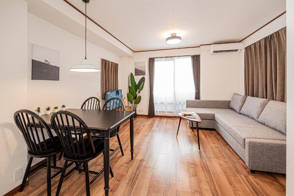 a living room with a table and a couch at Tokyo Stay House Hirai in Tokyo