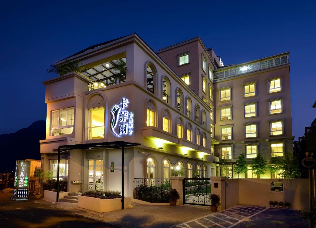 a large building with a sign on it at night at Caffir Garden Hotel in Jiji