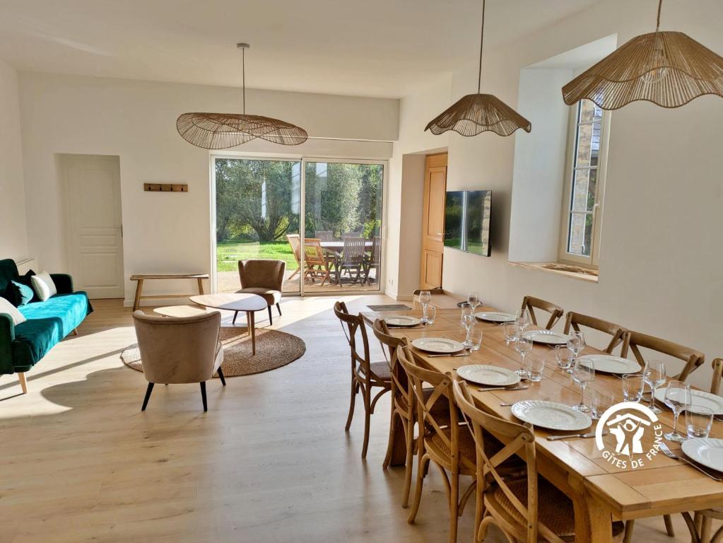 a dining room with a table and chairs at Chez Valentin, jusqu'à 9 personnes in Saint-Denis-dʼAnjou