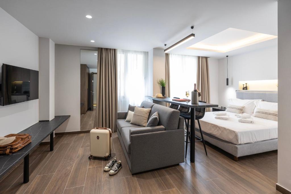 a living room with a couch and a bed at DOMIOS Suites Athens in Athens