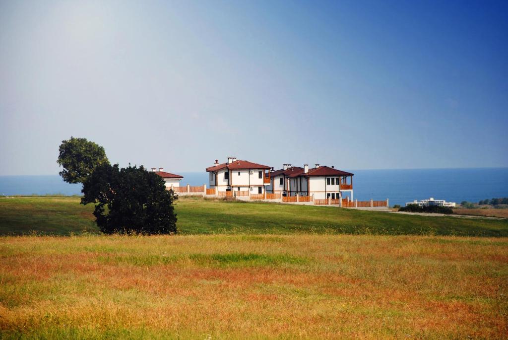 a large house on top of a hill with the ocean at Vis Velika in Velika