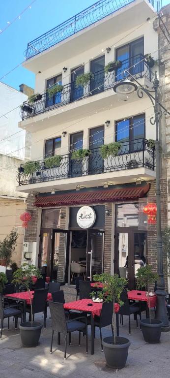 a restaurant with tables and chairs in front of a building at Maryon in Constanţa