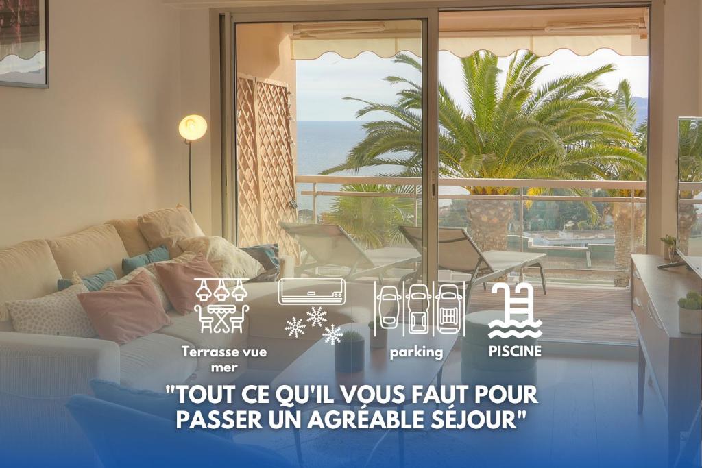 a living room with a window with a view of the ocean at Auré-Parking-Piscine-Terrasse-VCA in Cannes