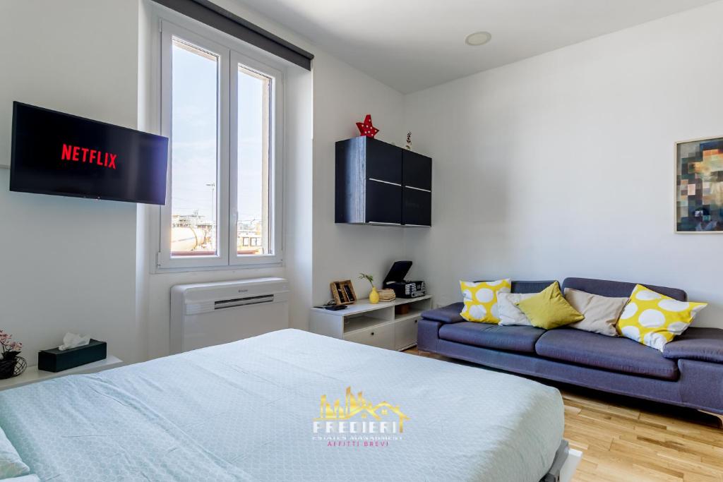 a bedroom with a bed and a couch at Milano Centrale Near The Station & Wi-Fi in Milan