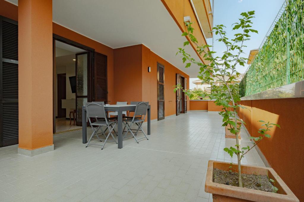 a patio with a table and chairs on it at Casa di Shrek 110mq grande terrazzo- 6 Posti letto- MODERNO TRILOCALE in Cesate