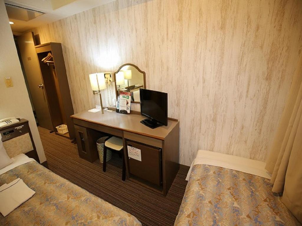 Postel nebo postele na pokoji v ubytování Apoa Hotel
