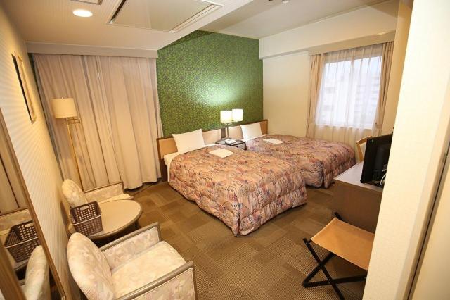 Postel nebo postele na pokoji v ubytování Apoa Hotel