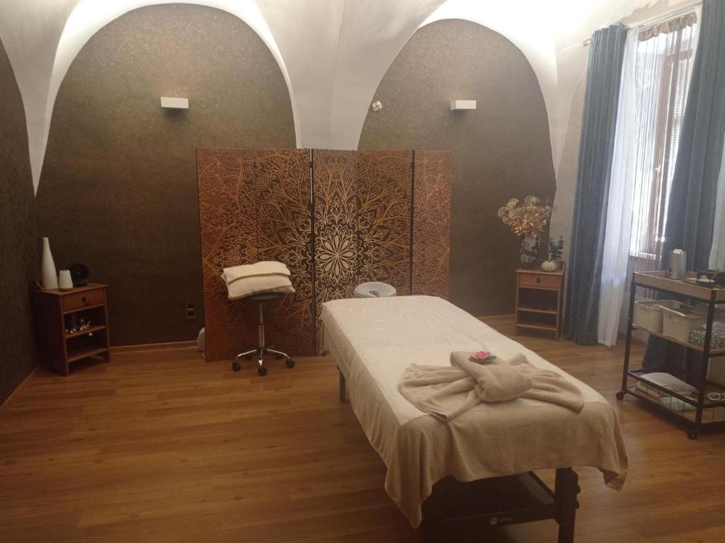 a bedroom with a bed with a towel on it at Apartmany SLOS in Banská Bystrica