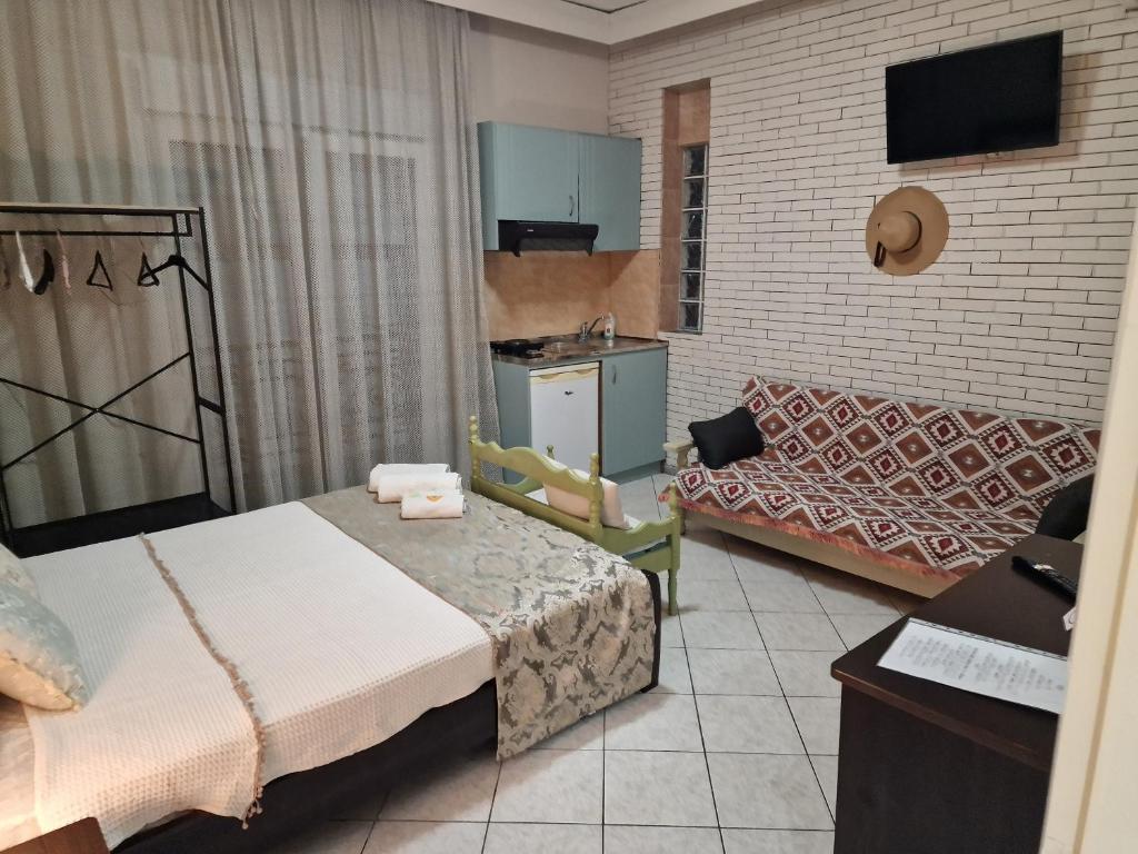 a small room with a bed and a couch at Vasilis & Nikolas Studios in Limenas