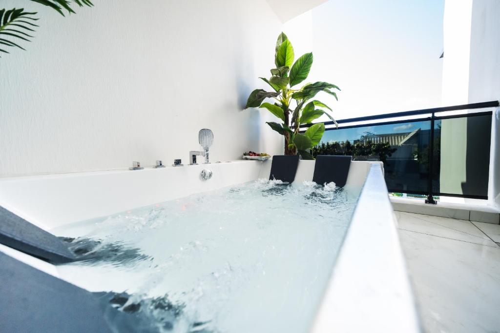 a bathtub with water in the middle of a room at Takeoff in Sainte-Marie