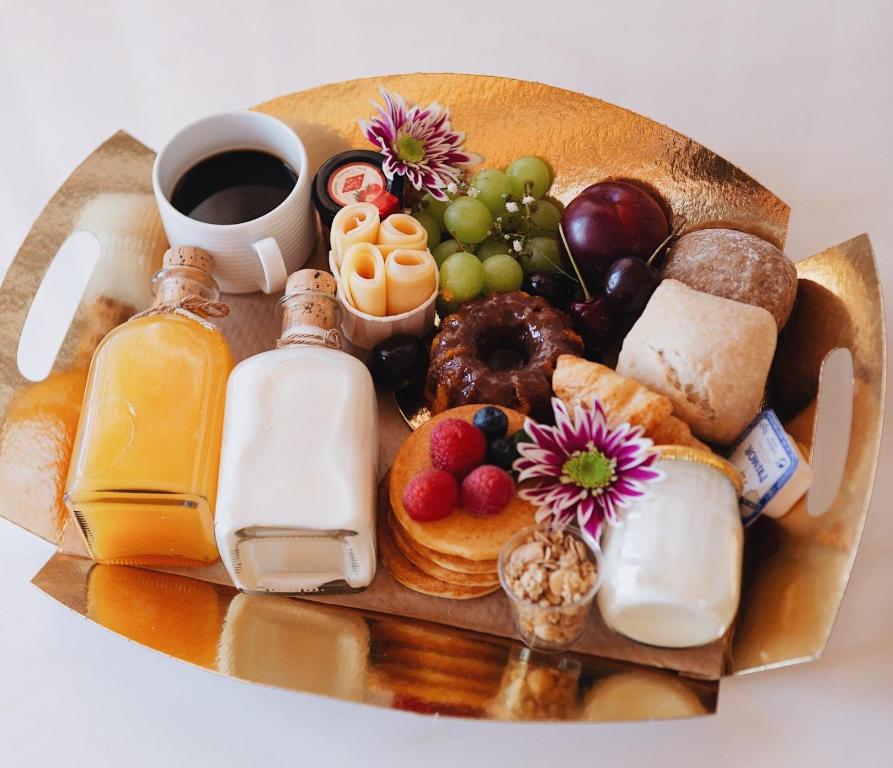 a tray of breakfast foods and a cup of coffee at ORM - Santa Teresa Apartments in Porto
