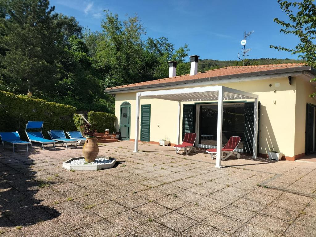 a patio with chairs and a pavilion with a house at Villa Gloria Guest House in Tovo San Giacomo