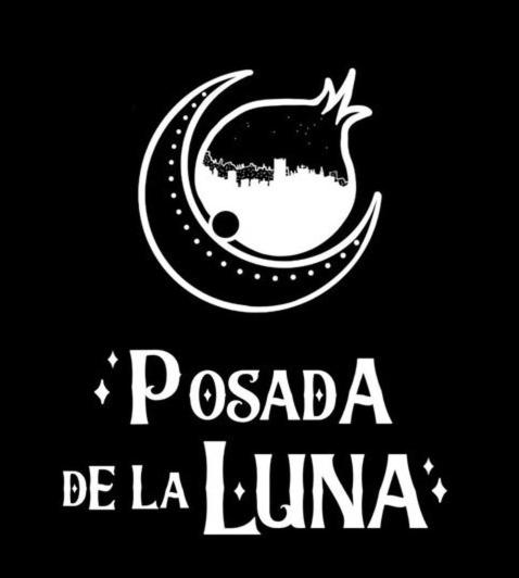 Hotel Posada de la Luna, a black and white sign with a crescent moon at Posada de la Luna in Granada