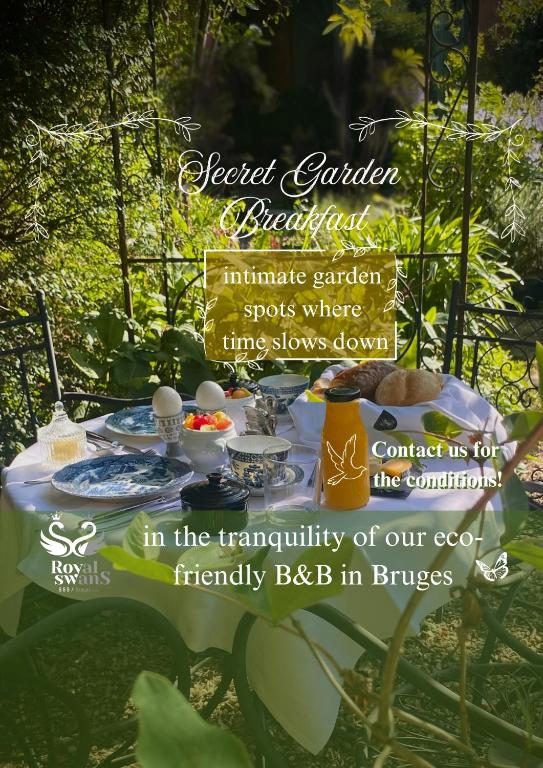 a table with food on it in a garden at B&amp;B Royal Swans in Bruges