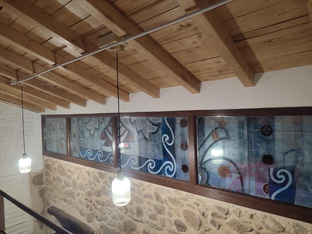 a room with a stained glass window on the wall at La herrera 30 in San Esteban de la Sierra