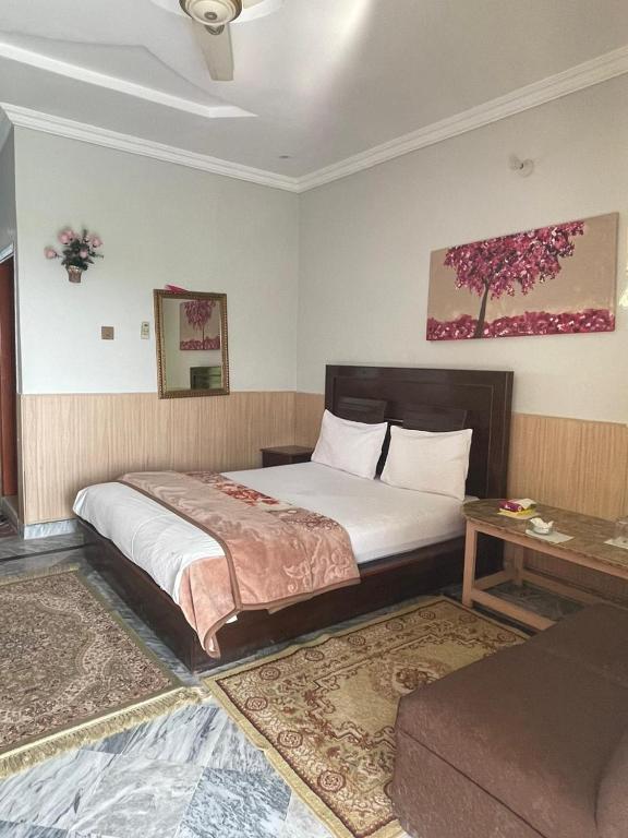 a bedroom with a large bed and a table at lake view hotel and resort in Khānpur