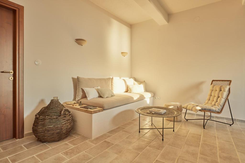 a living room with a couch and a chair at The Light House Chorefto in Chorefto