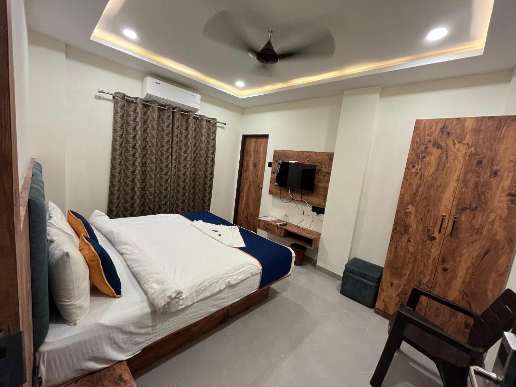 En eller flere senge i et værelse på Hotel MD Star