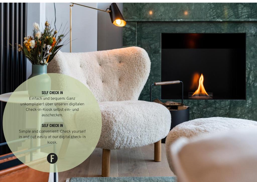 a living room with a chair and a fireplace at Black F Tower - Serviced Apartments in Freiburg im Breisgau