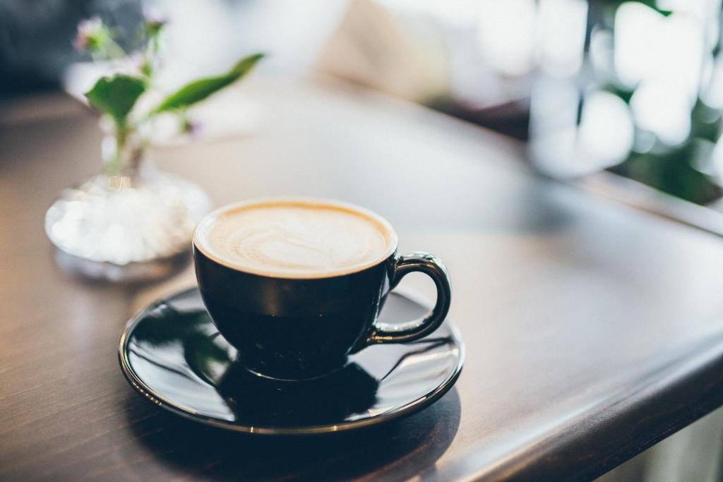 a cup of coffee sitting on a table at Hotel Pacific Kanazawa in Kanazawa