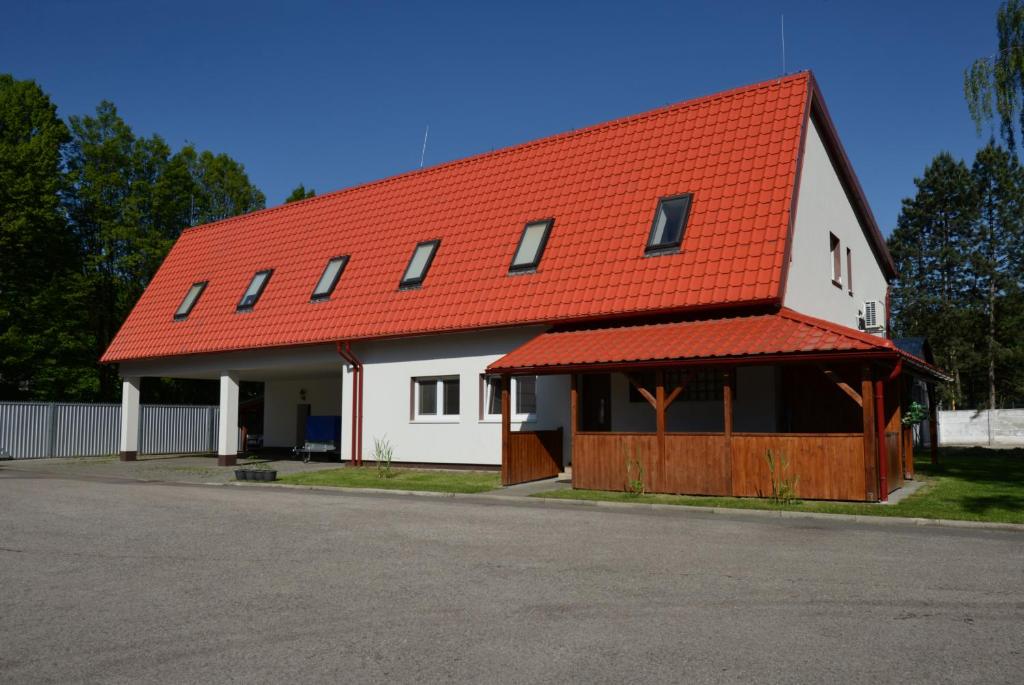 a white barn with an orange roof at Školící středisko ABENA s ubytováním in Ostrava