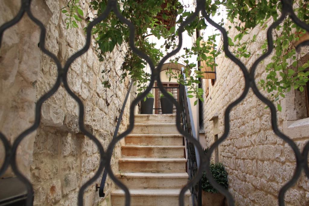 a staircase in a building through a fence at Mala Porta in Trogir