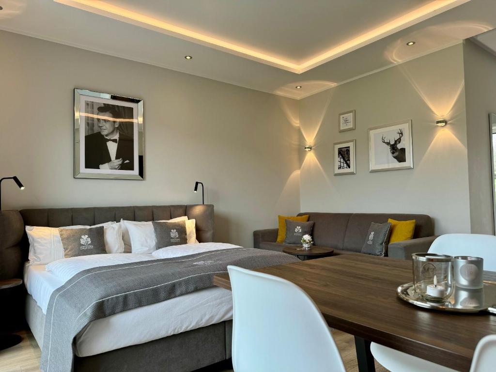 a bedroom with a bed and a dining room at DRIEHOF LifeStyle Classic Apt 5 in Tecklenburg