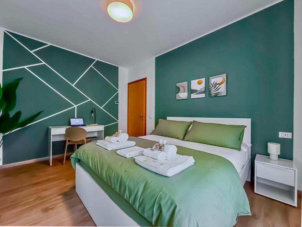 a bedroom with a large bed with a desk at Suite Deluxe Apartment Wellness Abano Terme in Abano Terme