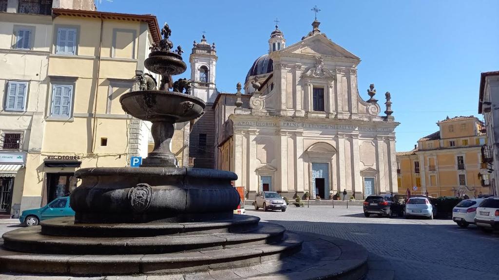 a water fountain in front of a building at Al Duomo in Ronciglione