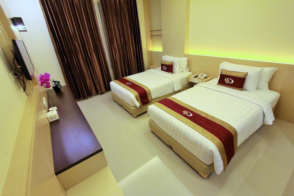 Postel nebo postele na pokoji v ubytování Grand Parama Hotel