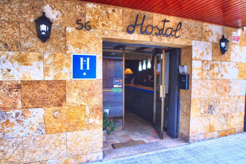 a building with a hotel sign on the side of it at Hostal Isabel in Blanes