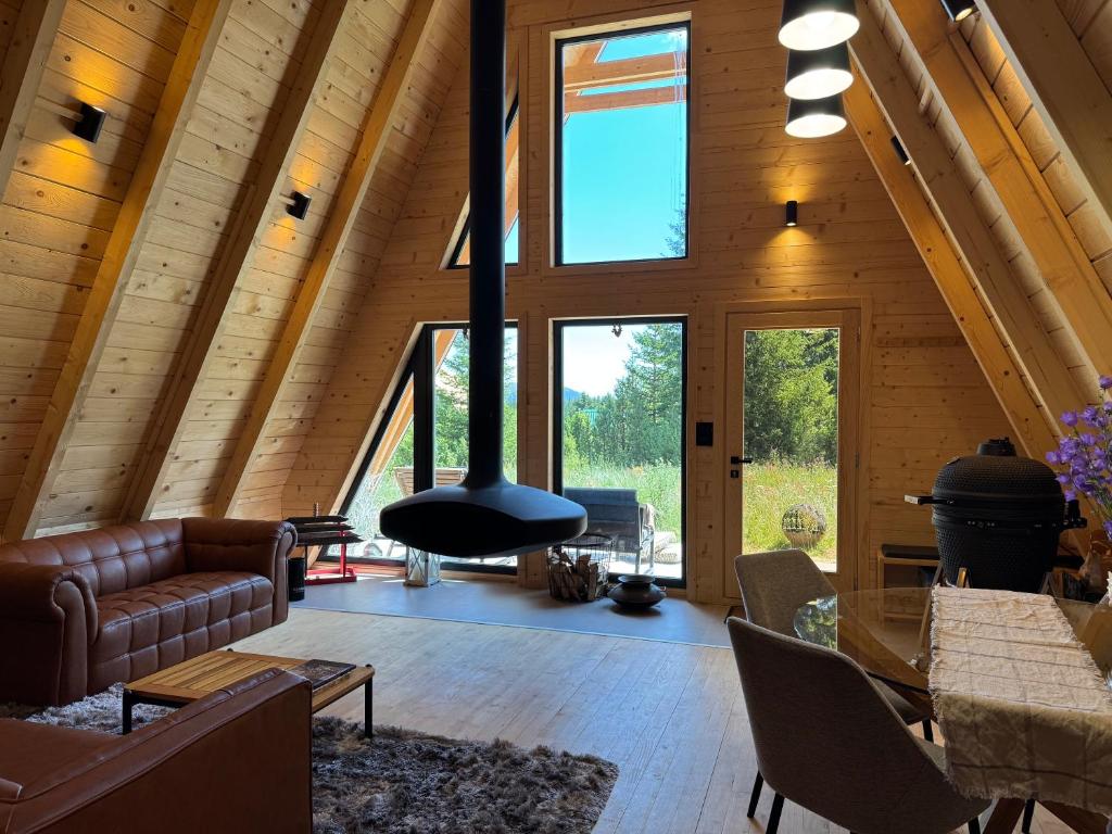 a living room with a fireplace in a wooden house at Hygge villa in Žabljak