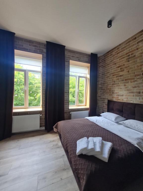 a bedroom with a large bed with two towels on it at Апартаменти в центрі по вул Л Українки,46 in Luts'k