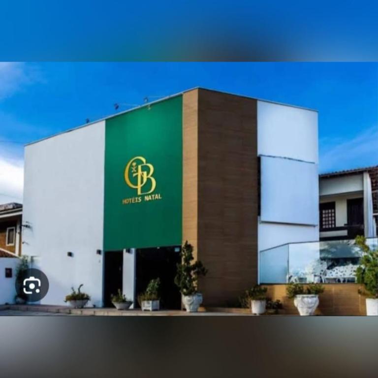 a building with a green sign on the side of it at GB Hoteis Natal in Natal