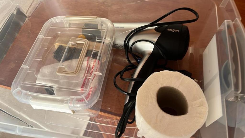 a box with a cell phone and a roll of toilet paper at Hostal Malú in San Pedro de Atacama
