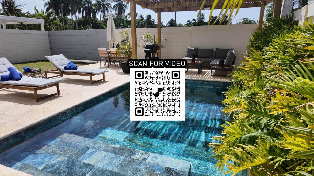 a swimming pool with a sign that reads santa fire web at Beach House With Private Pool in Las Terrenas