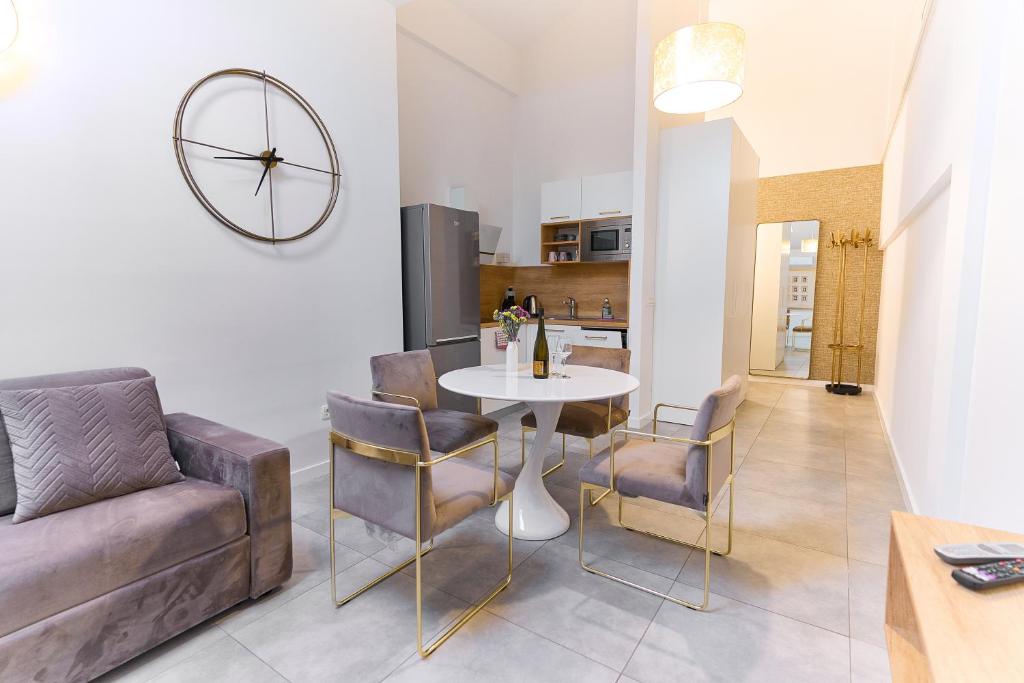 a living room with a couch and a table and chairs at Apartments Lukas 7 in Zadar