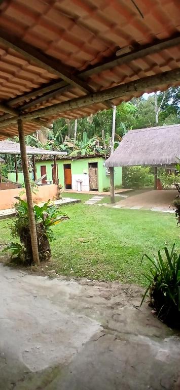 an outside view of a house with a yard at Camping Refugio SacodoCeu2026 in Saco do Ceu