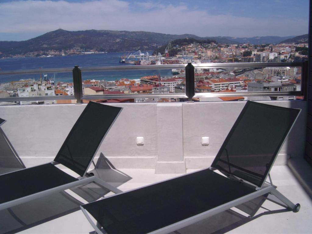 two chairs sitting on top of a roof with a view at Zenit Vigo in Vigo